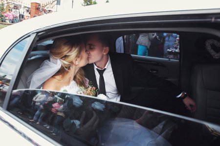 Married couples kissing each other in the car