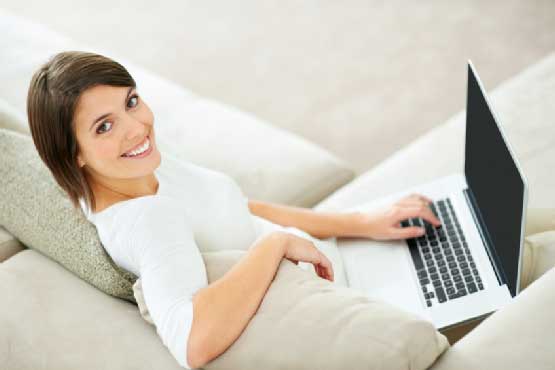 Smiling woman using laptop