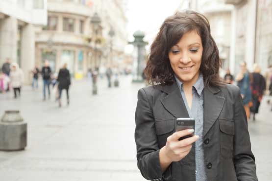 Smiling woman using cellphone