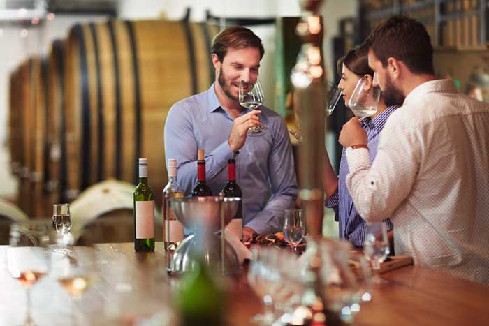 Heterosexual couple tasting white wine